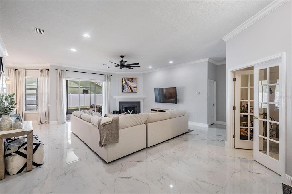 28335 Glade Fern Court Wesley Chapel, FL 33543 - Photo 12 of 44 a living room with furniture and a flat screen tv