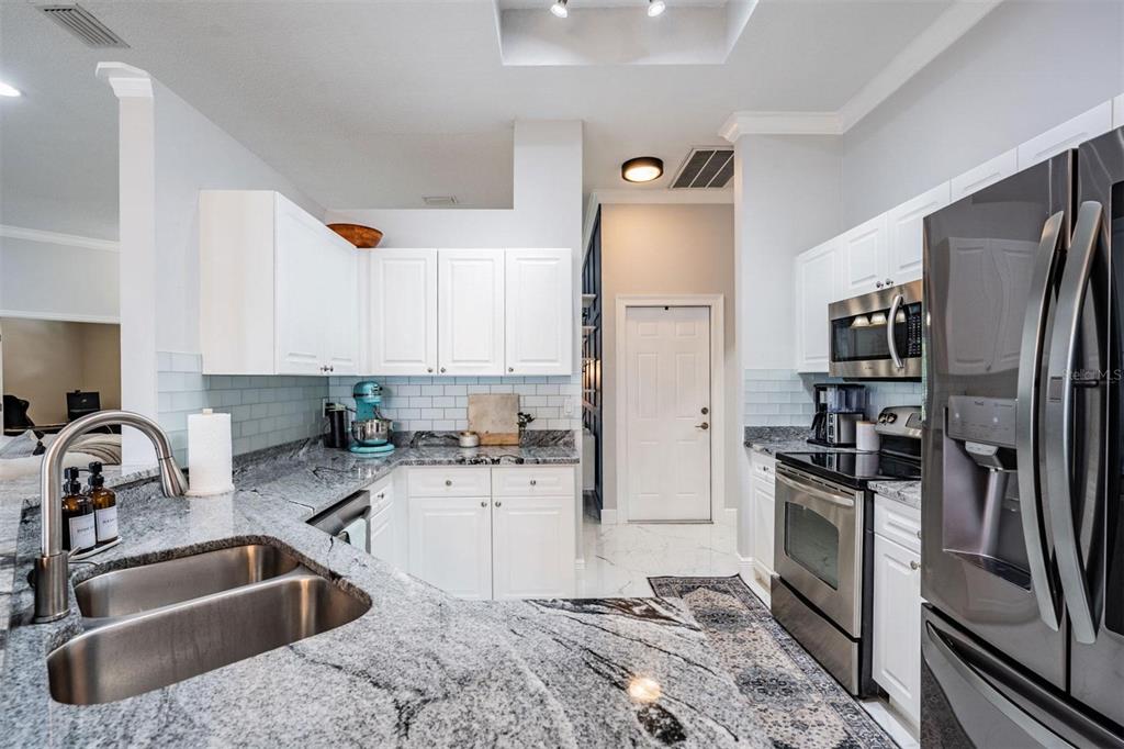 28335 Glade Fern Court Wesley Chapel, FL 33543 - Photo 17 of 44 a kitchen with a sink cabinets and stainless steel appliances