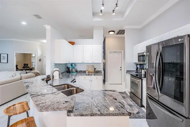 a kitchen with a refrigerator sink and stove