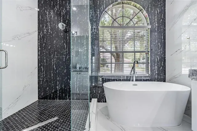 a white bath tub sitting next to a window