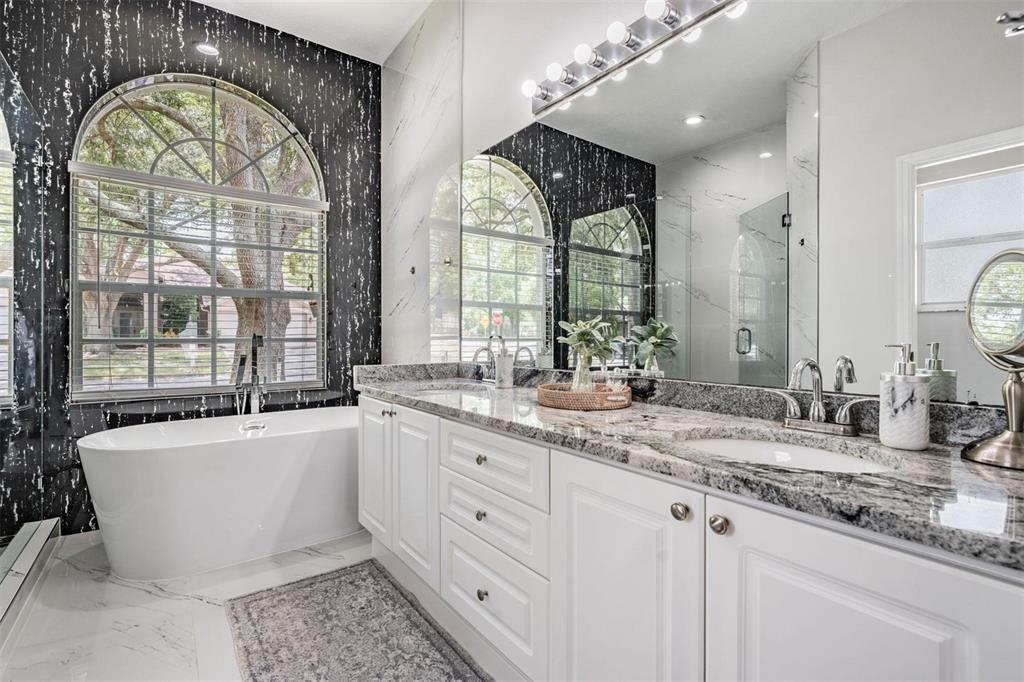 28335 Glade Fern Court Wesley Chapel, FL 33543 - Photo 28 of 44 a large bathroom with a large window and a sink