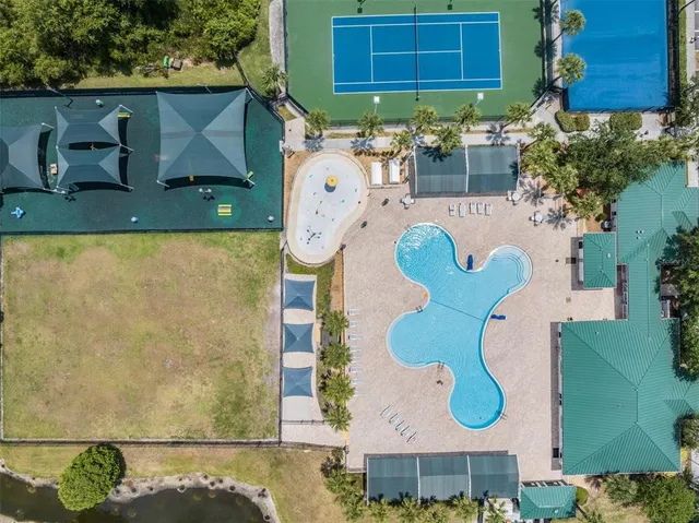 an aerial view of a house with a yard and garden