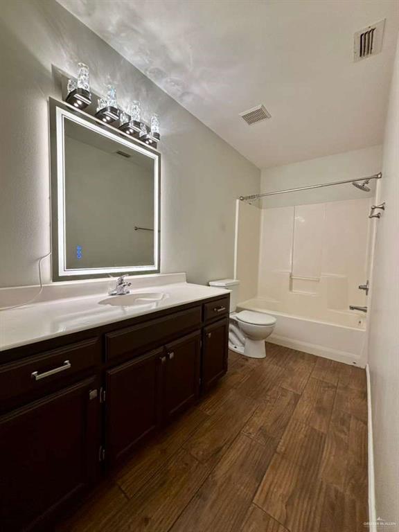 412 South 29th Street Hidalgo, TX 78557 - Photo 3 of 11 a bathroom with a toilet sink double vanity and mirror