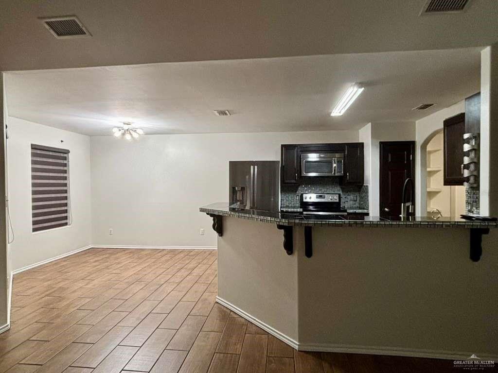 412 South 29th Street Hidalgo, TX 78557 - Photo 6 of 11 a kitchen with a refrigerator and a sink