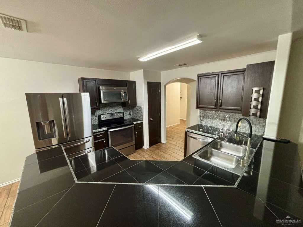 412 South 29th Street Hidalgo, TX 78557 - Photo 7 of 11 a kitchen with stainless steel appliances a refrigerator and a sink