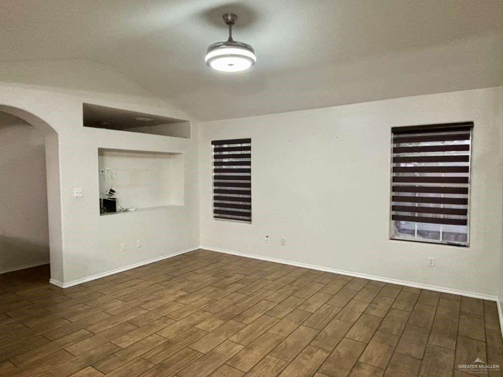 412 South 29th Street Hidalgo, TX 78557 - Photo 8 of 11 wooden floor in an empty room with a window