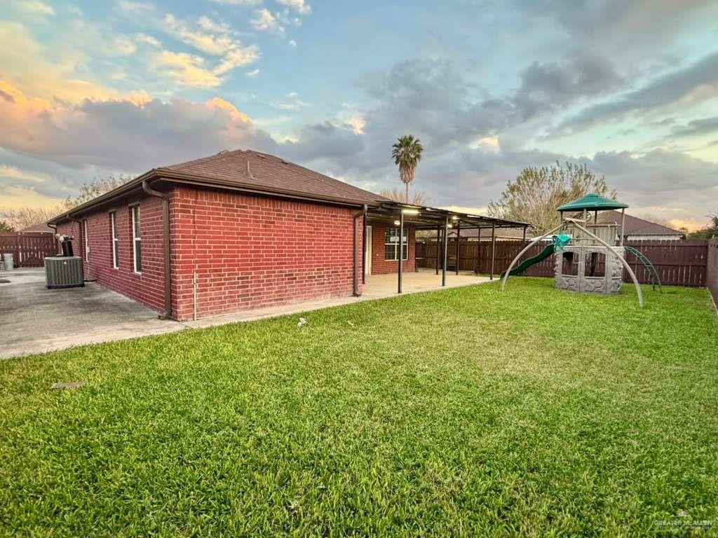 412 South 29th Street Hidalgo, TX 78557 - Photo 10 of 11 a view of a backyard with plants and a slide