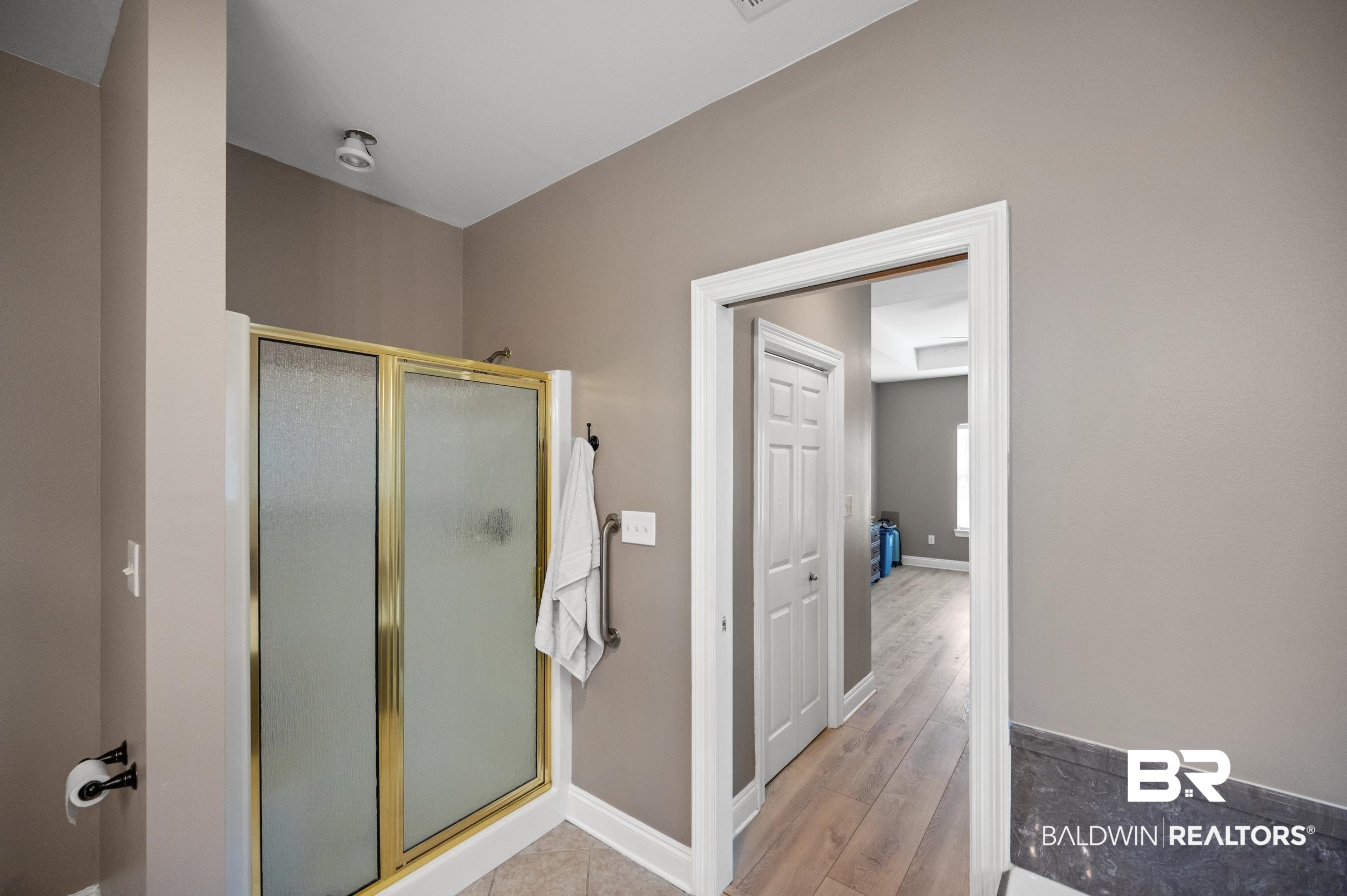 108 Natchez Trace Foley, AL 36535 - Photo 21 of 35 Bathroom featuring wood-type flooring and a shower with shower door