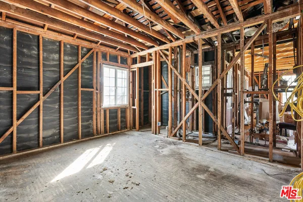 a view of an empty room with wooden walls
