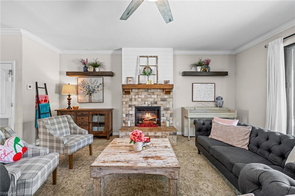 4754 Abaca Circle Naples, FL 34119 - Photo 6 of 46 a living room with furniture and a fireplace