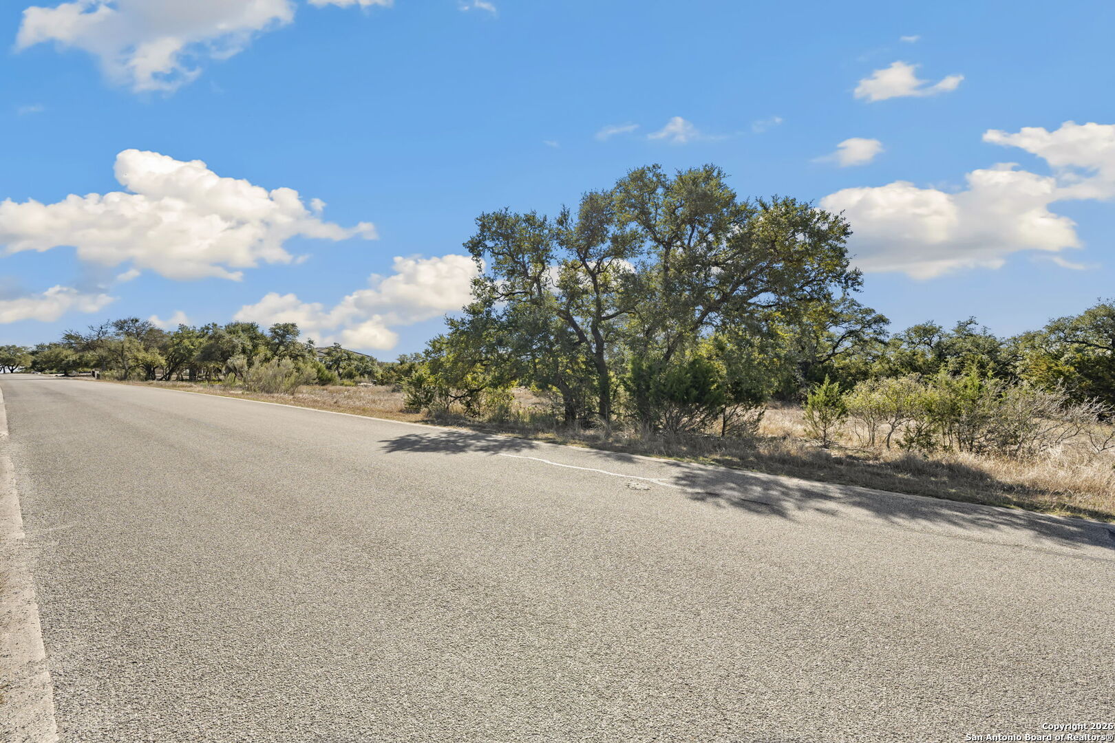7810 Ramble Ridge San Antonio, TX 78266 - Photo 6 of 17 a view of a road with a building in the background
