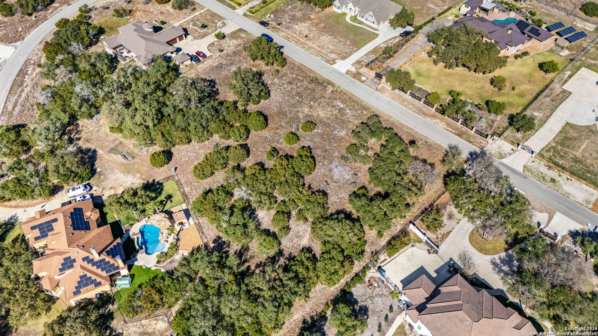 7810 Ramble Ridge San Antonio, TX 78266 - Photo 9 of 17 an aerial view of a house with a yard and wooden fence