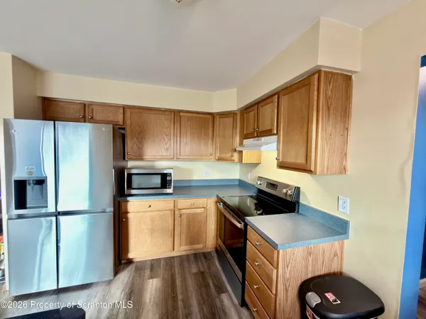 a kitchen with a sink a refrigerator a stove and cabinets