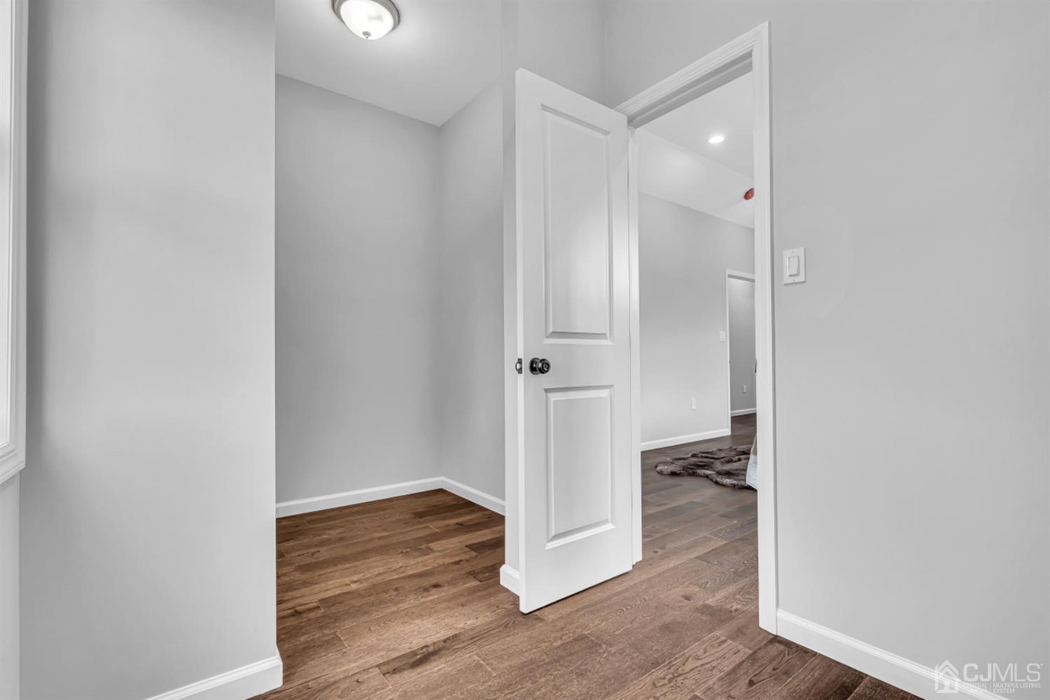 10 Dayton Road Edison, NJ 08817 - Photo 26 of 35 an empty room with wooden floor and a bathroom