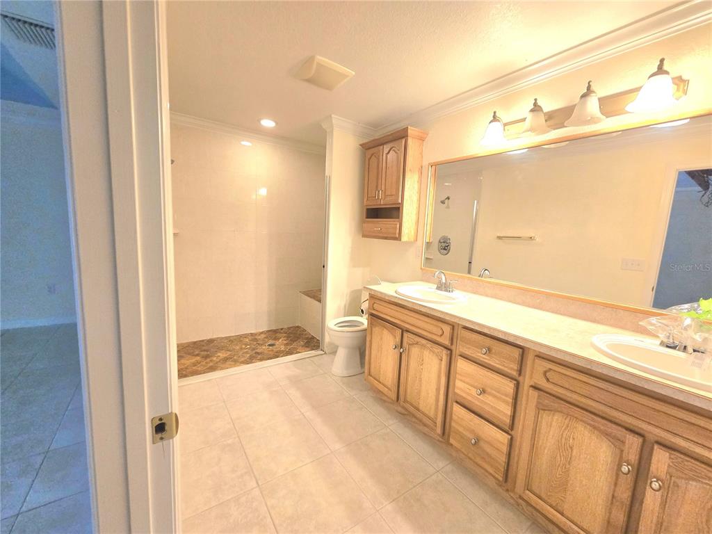 820 Shamrock Drive Sebring, FL 33875 - Photo 17 of 38 a spacious bathroom with a double vanity sink and a mirror