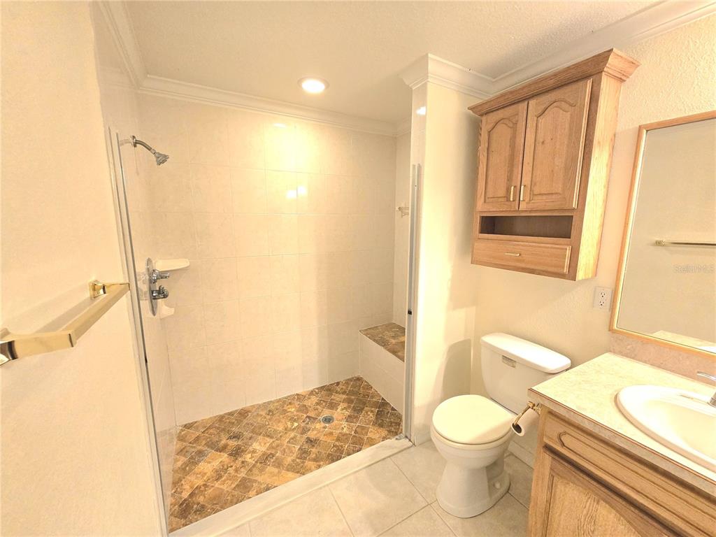 820 Shamrock Drive Sebring, FL 33875 - Photo 19 of 38 a bathroom with a granite countertop sink toilet and shower