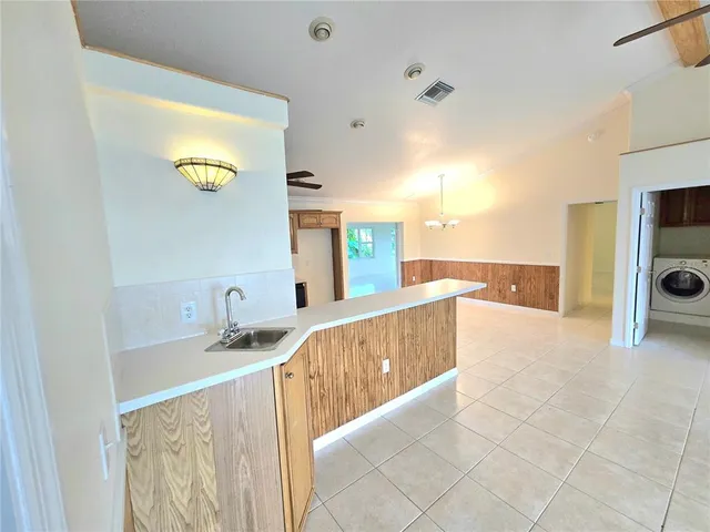 a view of a kitchen with a sink and a fireplace