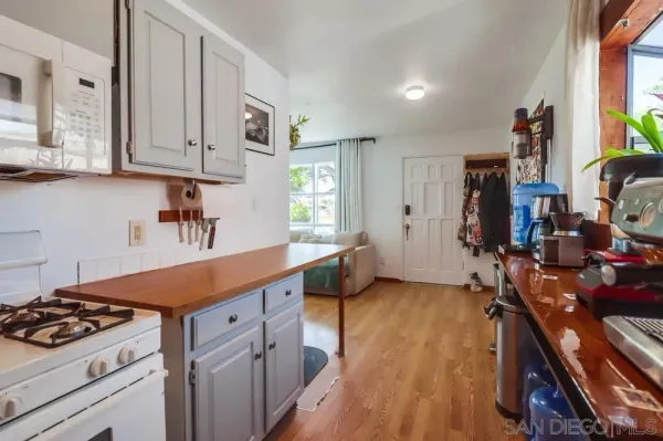 a kitchen with white cabinets and appliances