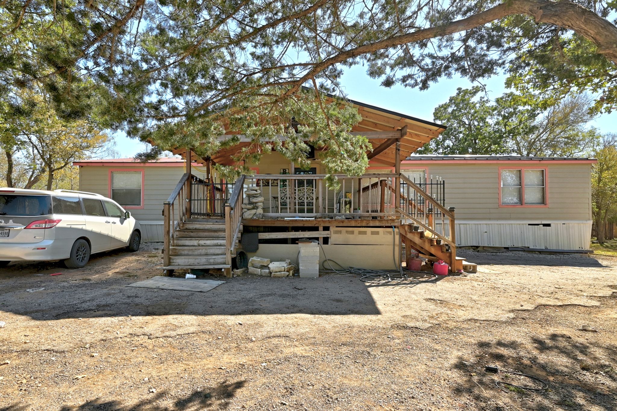 Manufactured / mobile home with stairs and a wooden deck