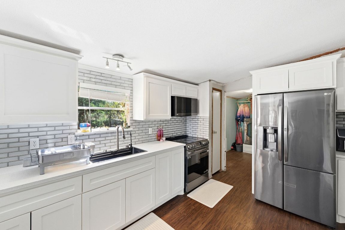 1485 Pettytown Road Dale, TX 78616 - Photo 11 of 36 a kitchen with stainless steel appliances a refrigerator sink and stove