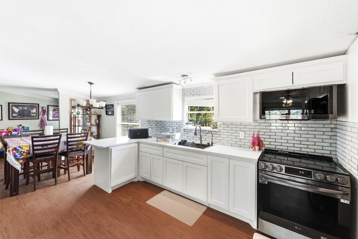 1485 Pettytown Road Dale, TX 78616 - Photo 12 of 36 a kitchen with stainless steel appliances a stove sink and microwave