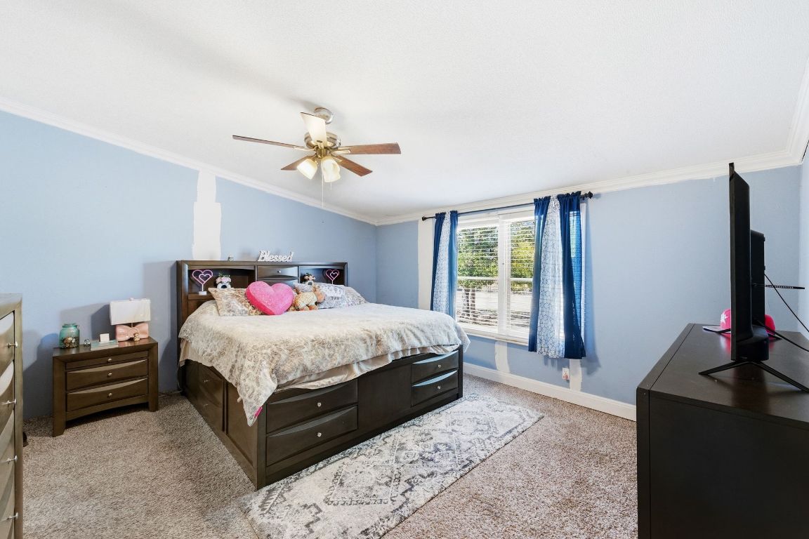 1485 Pettytown Road Dale, TX 78616 - Photo 13 of 36 a bedroom with a bed and a flat tv screen on a dresser