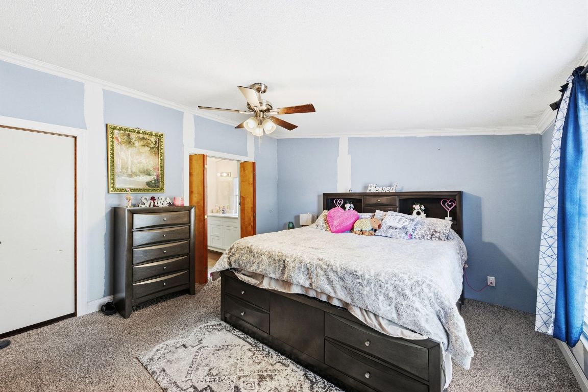 1485 Pettytown Road Dale, TX 78616 - Photo 14 of 36 a bedroom with a bed and a chandelier