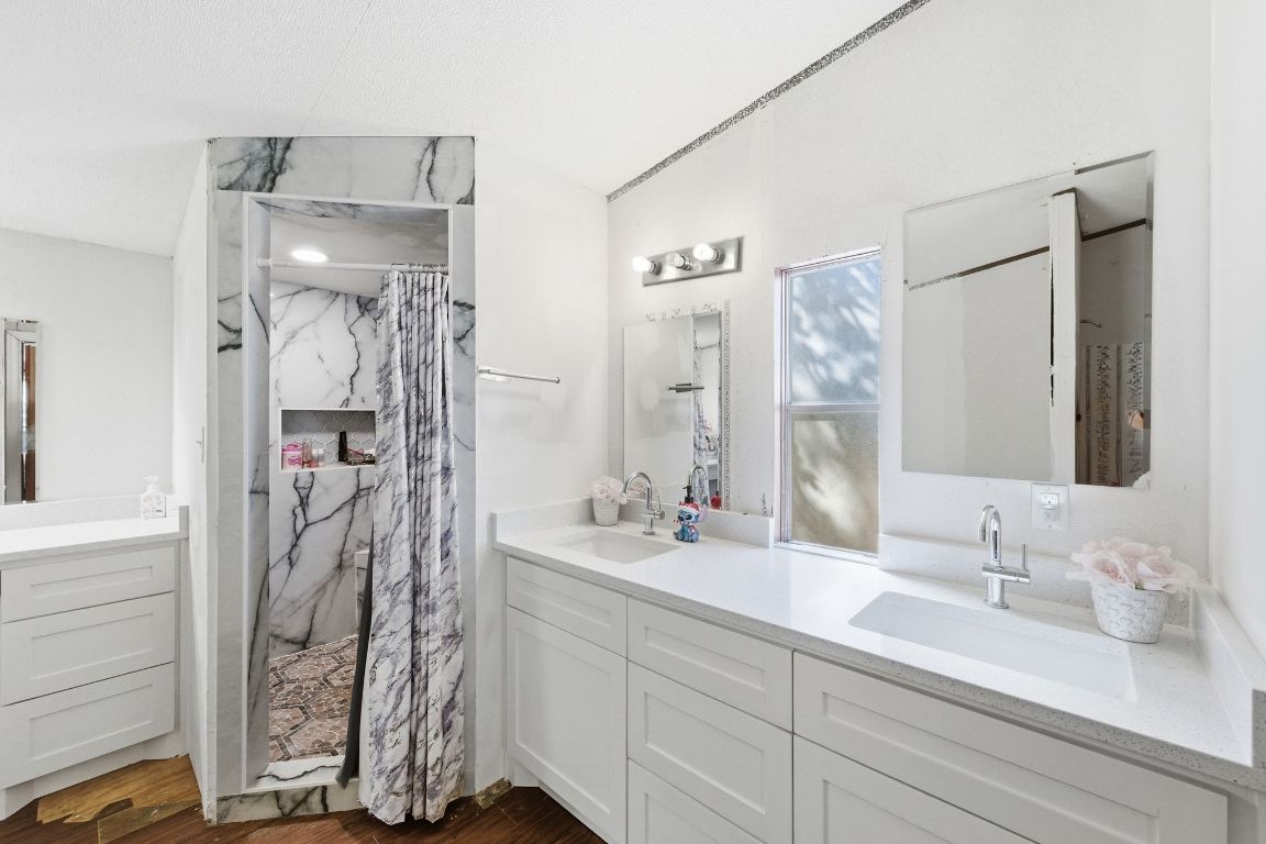 1485 Pettytown Road Dale, TX 78616 - Photo 15 of 36 a bathroom with a double vanity sink mirror and shower