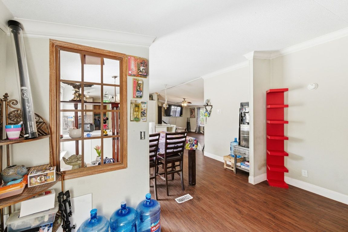 1485 Pettytown Road Dale, TX 78616 - Photo 19 of 36 a view of a workspace with furniture and wooden floor