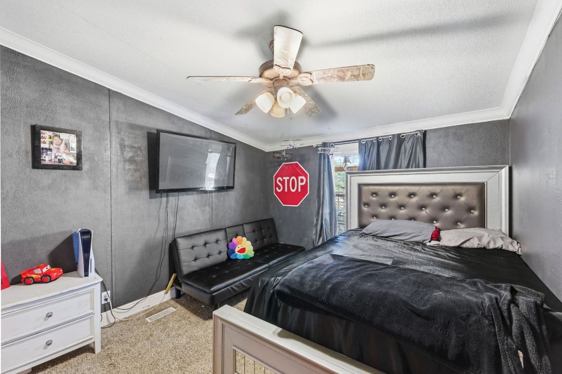 1485 Pettytown Road Dale, TX 78616 - Photo 20 of 36 a bedroom with a bed and a chandelier