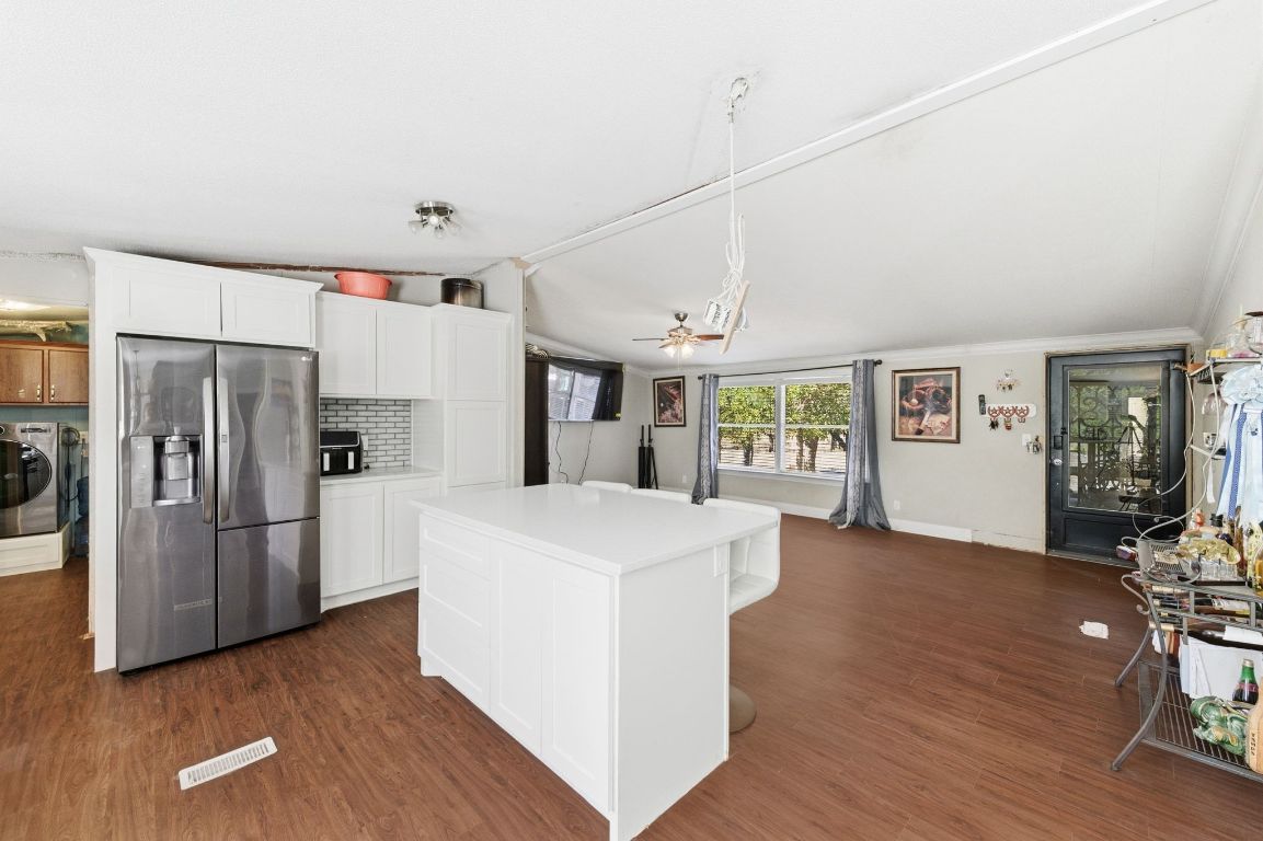 1485 Pettytown Road Dale, TX 78616 - Photo 36 of 36 a view of kitchen with refrigerator stove and wooden floor