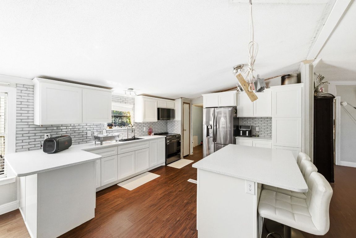 1485 Pettytown Road Dale, TX 78616 - Photo 9 of 36 a large kitchen with a table and chairs in it