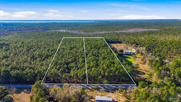 a view of a yard with wooden floor and lake view