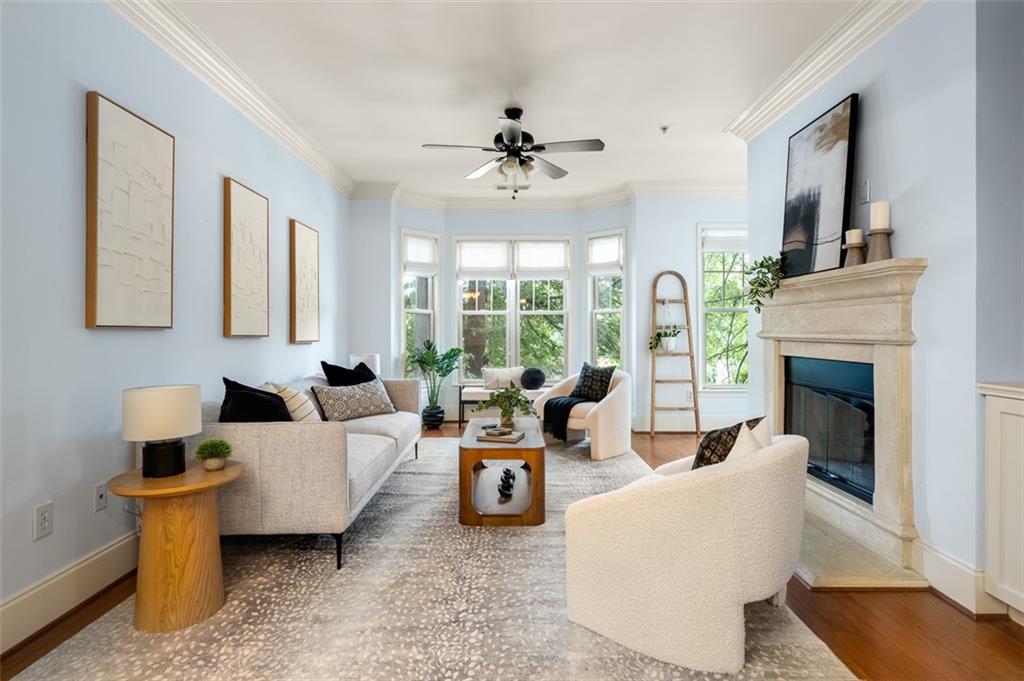 825 Highland Lane Northeast, Unit 1112 Atlanta, GA 30306 - Photo 1 of 39 a living room with furniture a fireplace and a chandelier