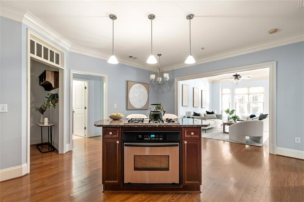 825 Highland Lane Northeast, Unit 1112 Atlanta, GA 30306 - Photo 15 of 39 a kitchen with stainless steel appliances granite countertop a stove a sink dishwasher and a dining table with the view of living room