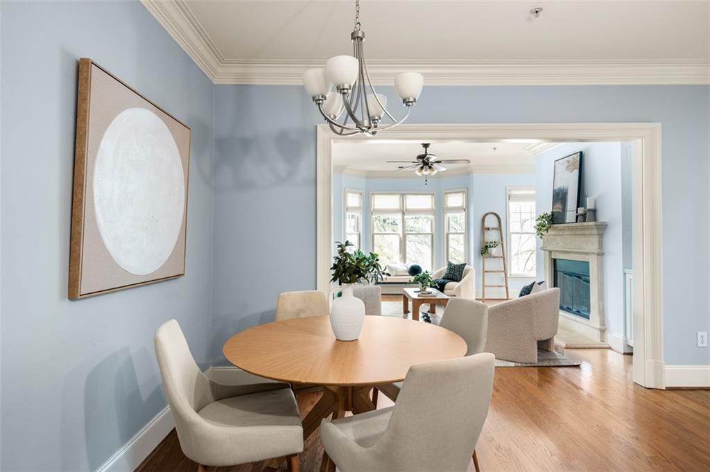 825 Highland Lane Northeast, Unit 1112 Atlanta, GA 30306 - Photo 16 of 39 a view of a dining room with furniture and wooden floor
