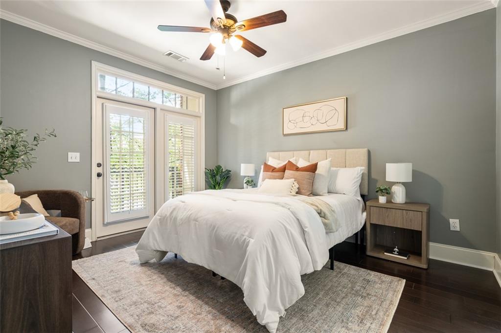 825 Highland Lane Northeast, Unit 1112 Atlanta, GA 30306 - Photo 17 of 39 a bedroom with a bed and wooden floor