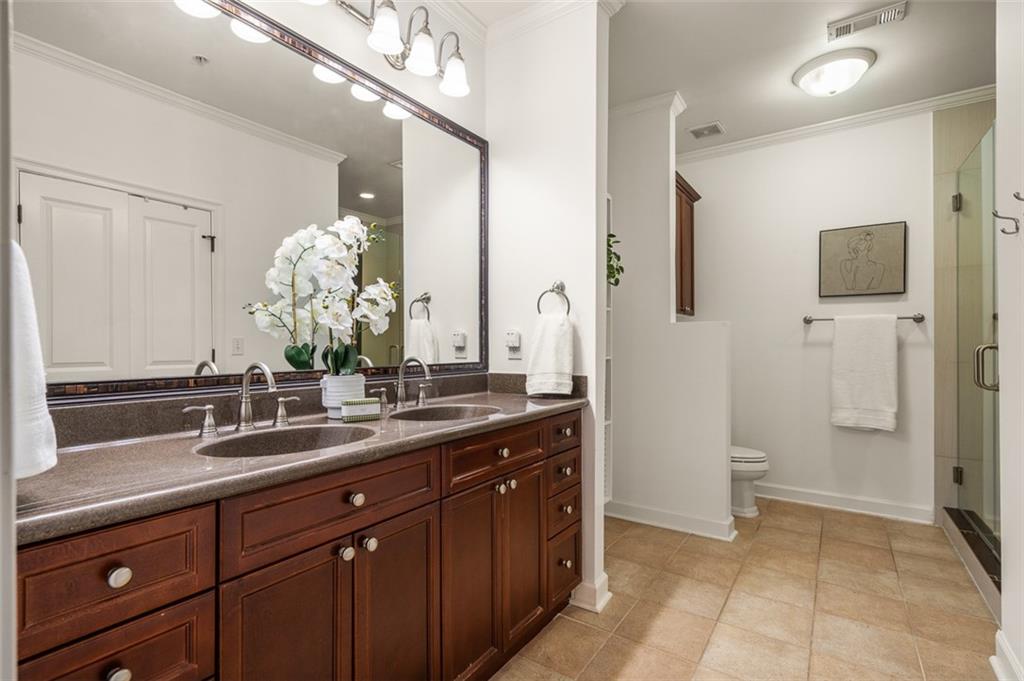 825 Highland Lane Northeast, Unit 1112 Atlanta, GA 30306 - Photo 20 of 39 a bathroom with a double vanity sink and mirror