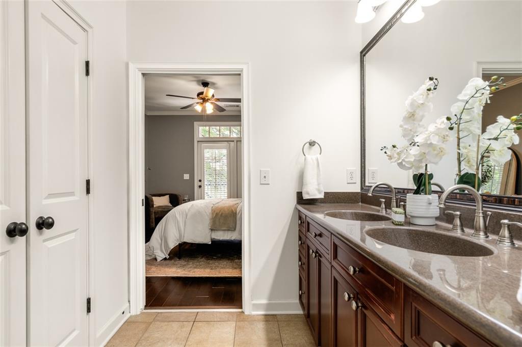 825 Highland Lane Northeast, Unit 1112 Atlanta, GA 30306 - Photo 21 of 39 a en suite bathroom with a granite countertop sink and a mirror