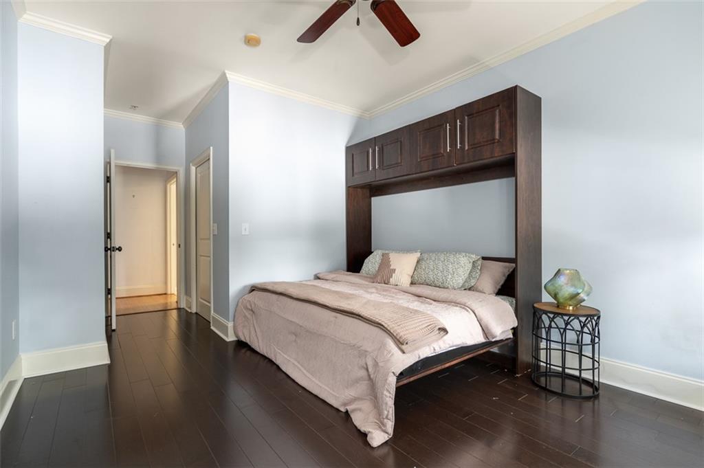 825 Highland Lane Northeast, Unit 1112 Atlanta, GA 30306 - Photo 26 of 39 a bedroom with a bed and a chandelier
