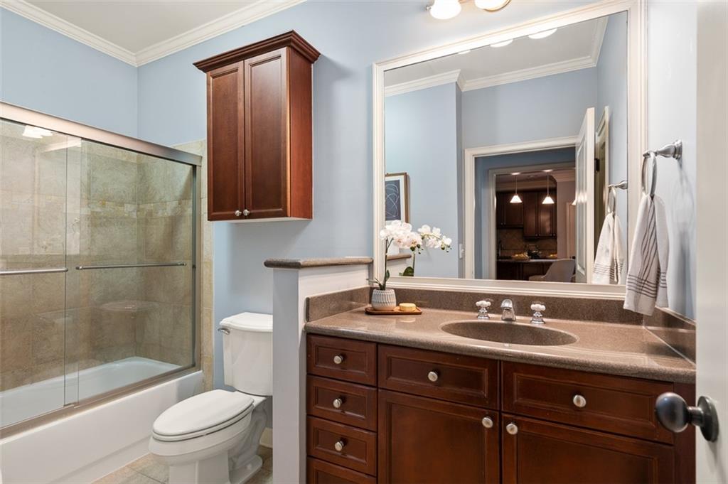825 Highland Lane Northeast, Unit 1112 Atlanta, GA 30306 - Photo 27 of 39 a bathroom with a sink a toilet and shower