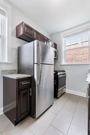 a kitchen with a refrigerator and a sink
