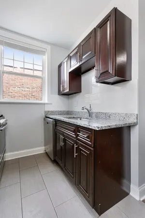 a kitchen with stainless steel appliances granite countertop a stove and a microwave