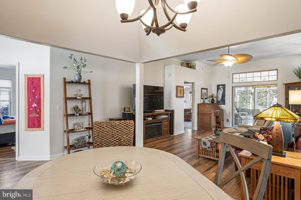 a living room with furniture a flat screen tv and kitchen view
