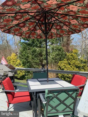 a view of a chair and table in the garden