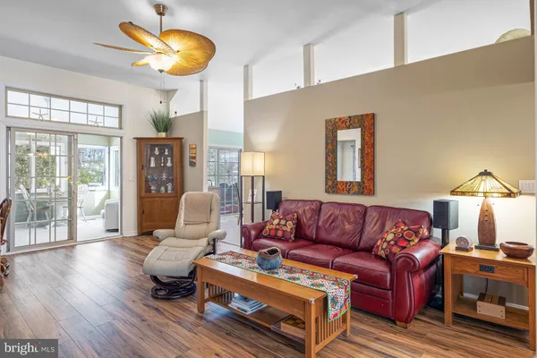 a living room with furniture a lamp and a large window