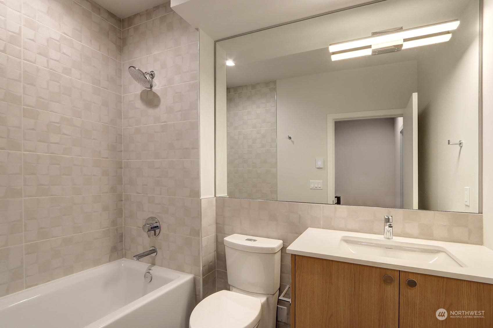 17342 Bothell Way Northeast, Unit H Bothell, WA 98011 - Photo 16 of 19 a bathroom with a granite countertop sink a toilet and a bathtub