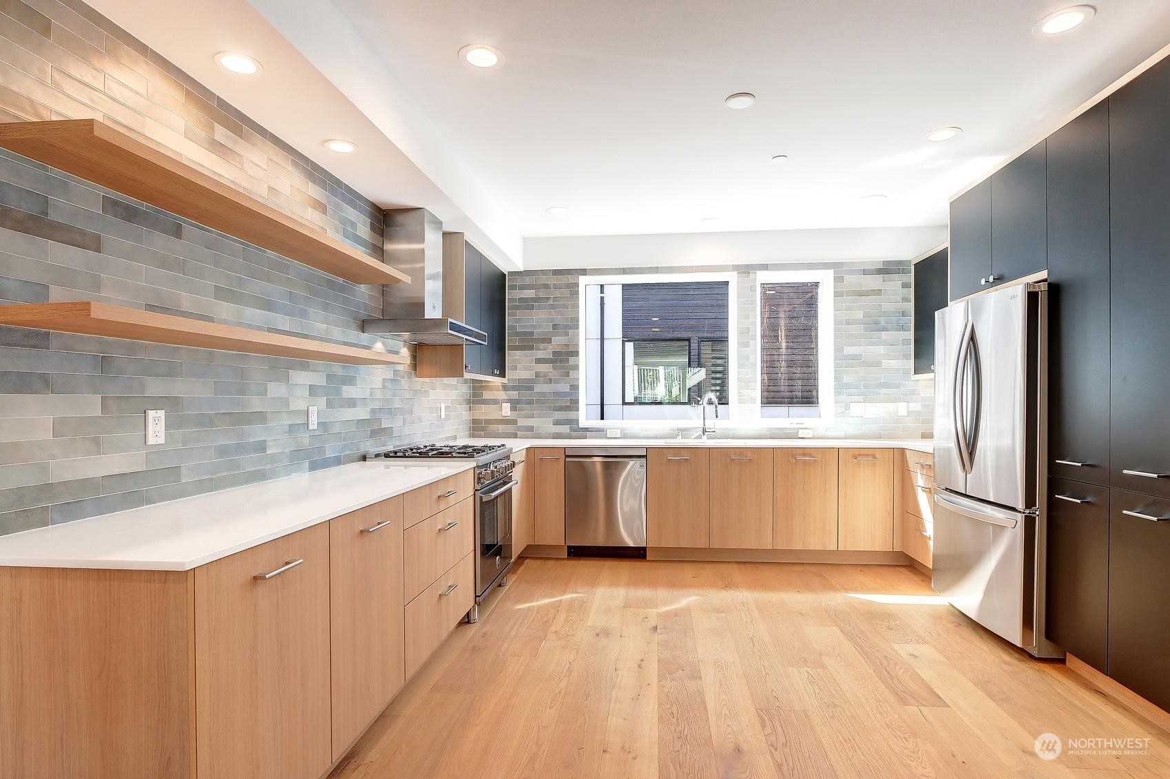 17342 Bothell Way Northeast, Unit H Bothell, WA 98011 - Photo 2 of 19 a large kitchen with a large window and stainless steel appliances