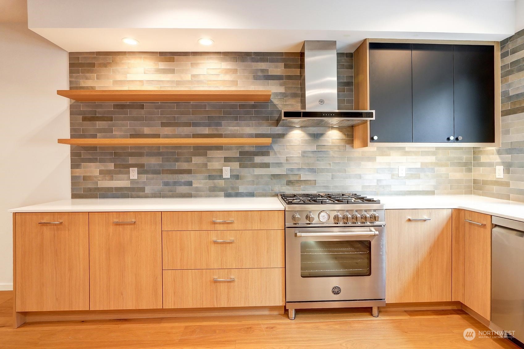 17342 Bothell Way Northeast, Unit H Bothell, WA 98011 - Photo 3 of 19 a kitchen with granite countertop a stove and a sink