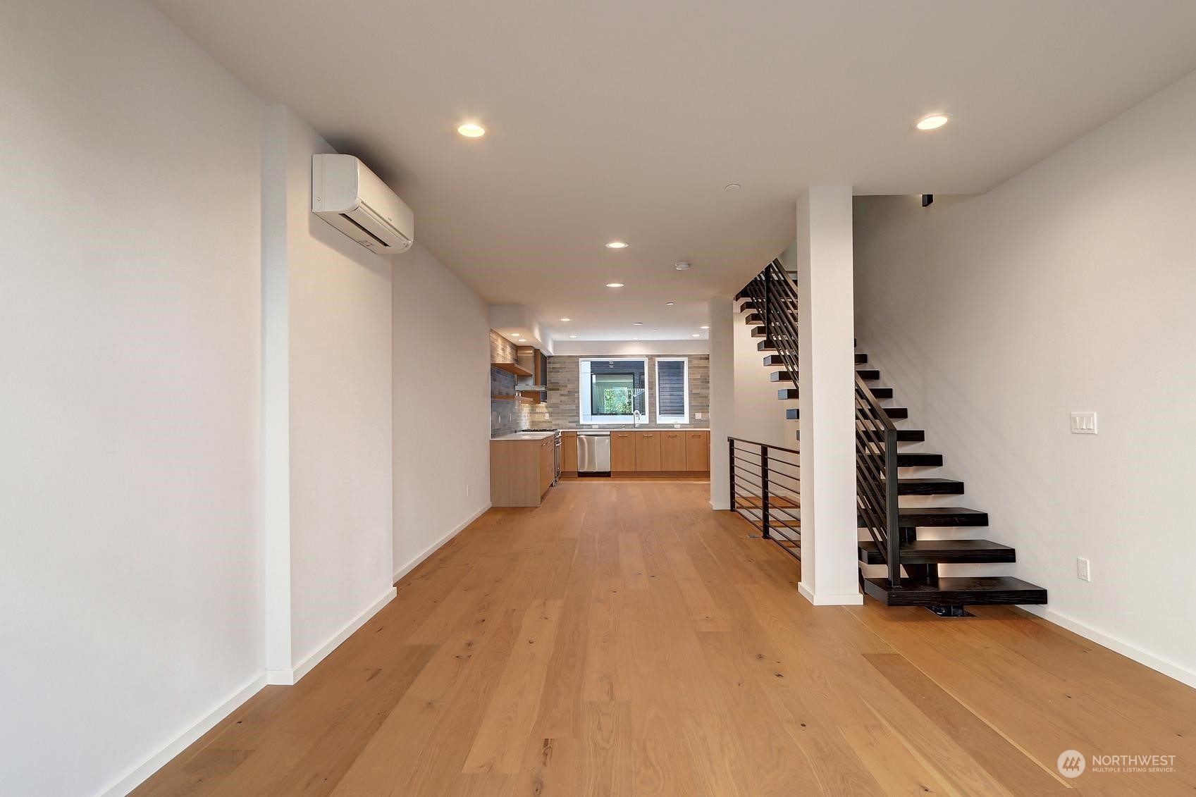 17342 Bothell Way Northeast, Unit H Bothell, WA 98011 - Photo 6 of 19 a view of wooden floor and windows in a room